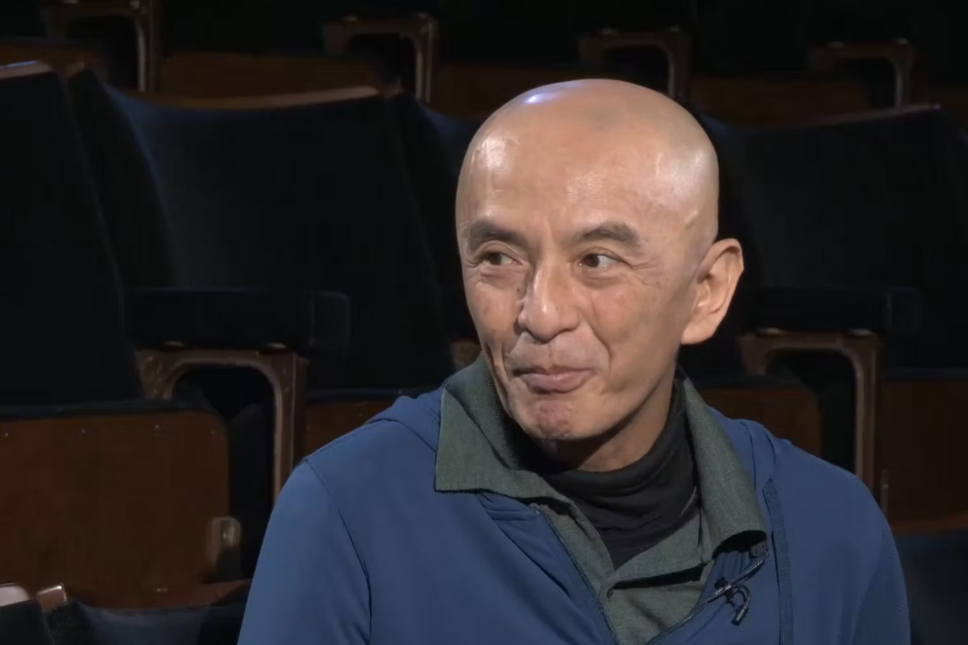 Saburo Teshigawara sitting in a theatre auditorium