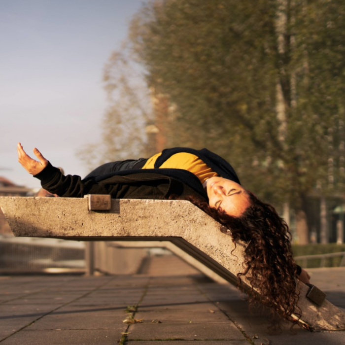 Raquel Meseguer lying down on a concrete structure, with hair flowing.