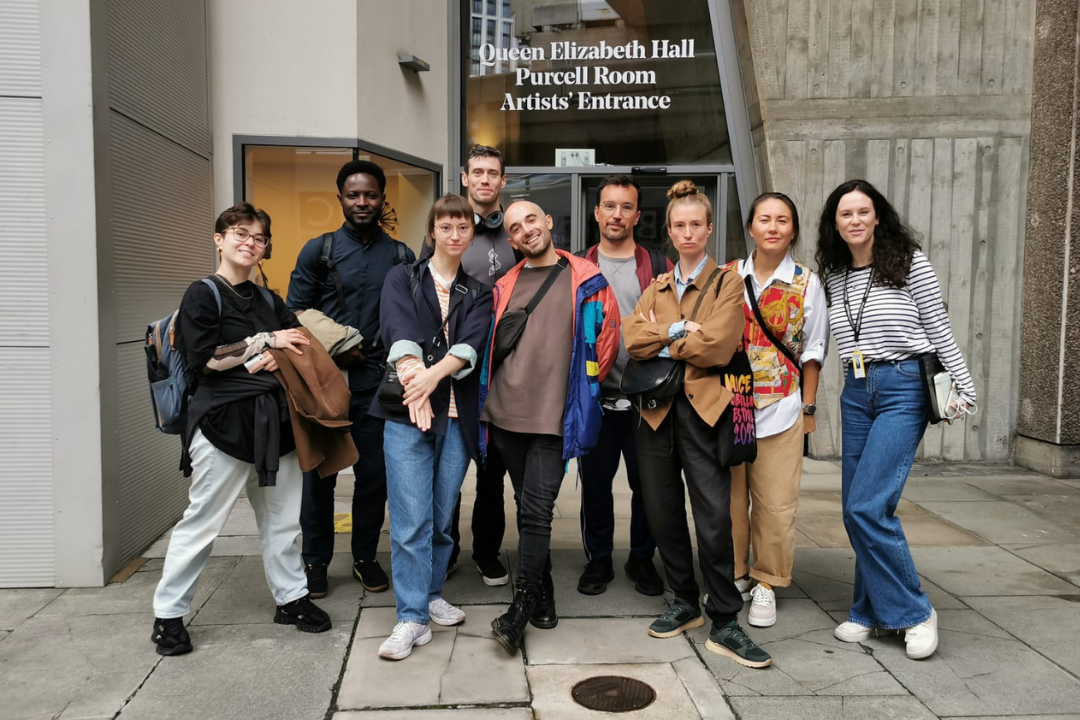 Group photo of Big Pulse Visiting Artists standing in front of the Southbank Centre.